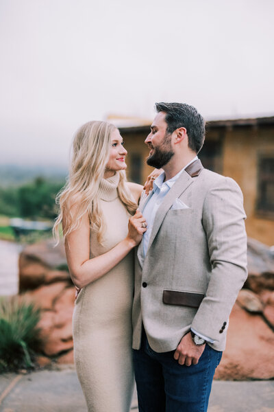 Portrait of couple smiling at each other outside after getting engaged