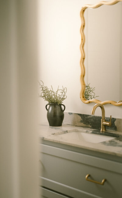 Neutral bathroom with wood frame mirror