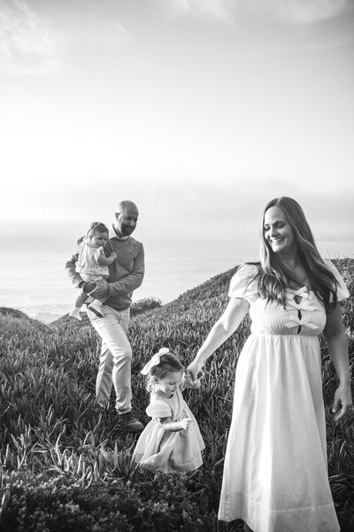 Family Photos in San Francisco Bay Area, featuring a family of four along the coast. Photo taken by photographer Alyx Jones. 