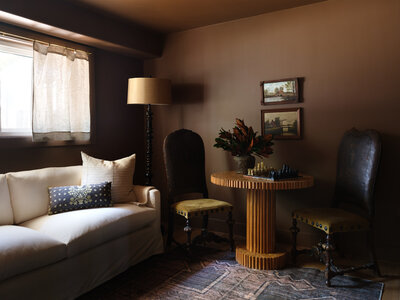 Project image of living space with green upholster antique chairs and chess board on wooden table, by Alexa at Home