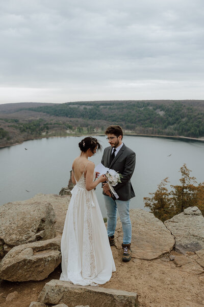 bride and groom saying vows on an overlook at devils lake