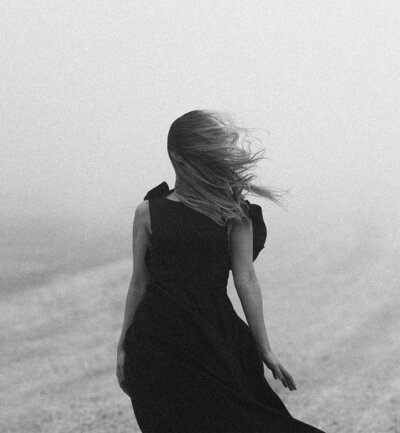 woman in a dress looking out into the ocean
