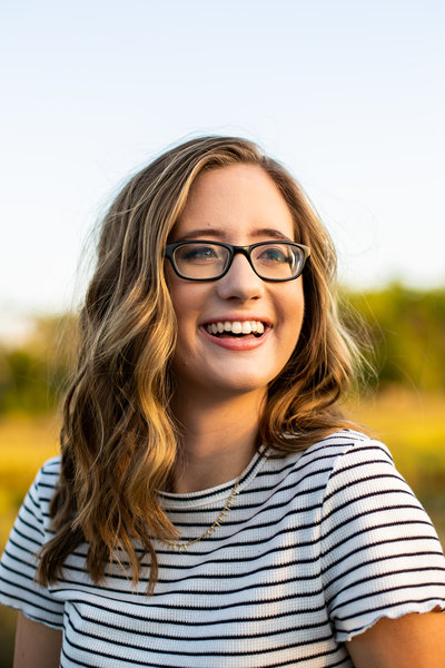 Candid shot of teen girl with glasses in striped shirt