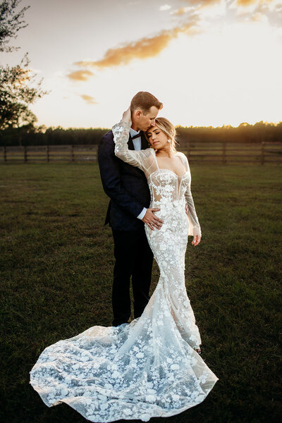 Bride and groom sharing a romantic moment during golden hour at their St. Augustine wedding.