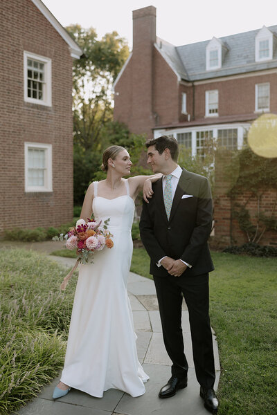bride and groom posing during sunset