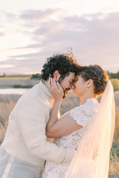 Wedding couple holding each other and posing for a picture.