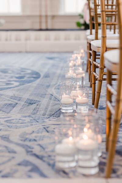 Elegant candles lining aisle at wedding ceremony
