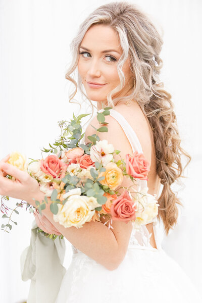 bright light and airy wedding photo of bride bouquet flowers wedding
