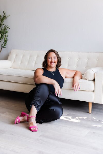 Therapist for moms, Kathryn Konicek, leaning against a couch