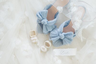 A pair of blue Loeffler Randall heels with ring boxes for a wedding flat lay. 