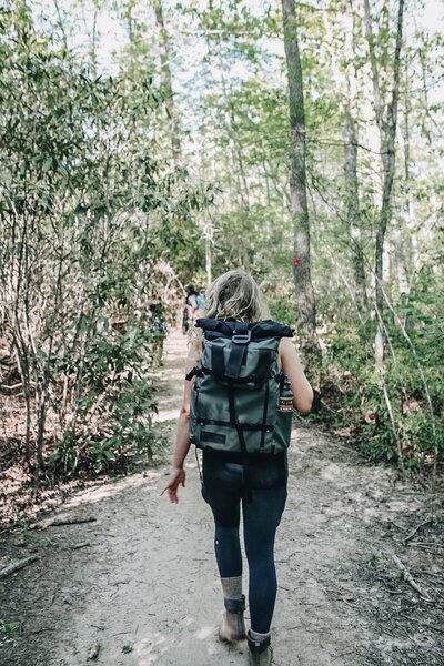 Marybeth Wells of LivingWells hiking on a trail and leading a group of people