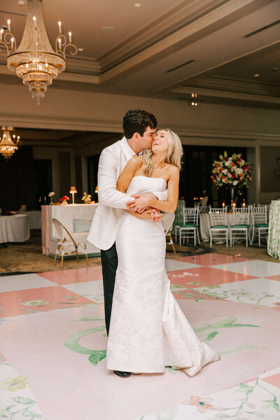 groom kisses his wife on the dance floor of their wedding reception at Lakeside Country Club