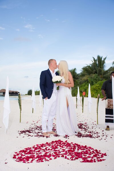 Bora Bora honeymoon planner bride and groom sitting on a dock