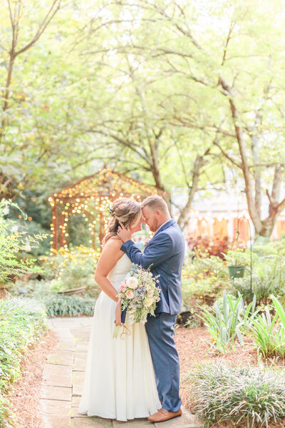 A couple at their wedding at Four Oaks Manor in Buford Georgia by Jennifer Marie Studios, light and airy Atlanta wedding photographer.