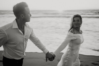 Bride & Groom holding each other on a rocky coast
