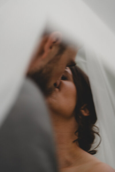 Wedding couple kiss under the veil