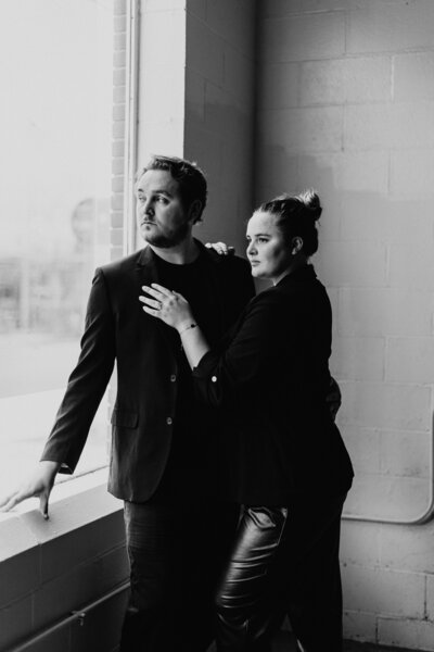 luxury wedding photographer cinematographer adam and becca looking out window