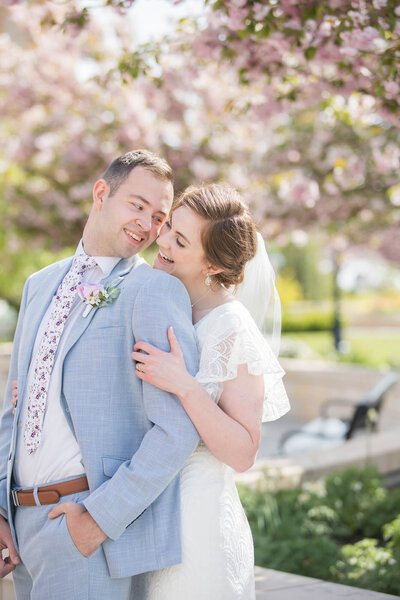 Bright and beautiful wedding moment of a bride and groom on the grounds of the Provo City Center Temple, moment  captured by las vegas wedding photographer.