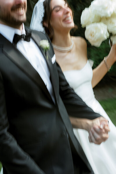 April M Payne Photography taken of a bride with a pearl necklace and soft, elegant puffy sleeves on her gown, with a softly blurred background creating a dreamy atmosphere.
