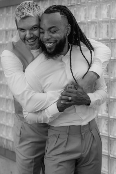 Black and white couple shoot showing close embrace of a LGBTQIA+ couple.