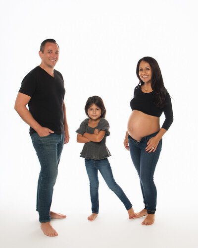 family photography queen city family standing on white backdrop all wearing jeans and blacks