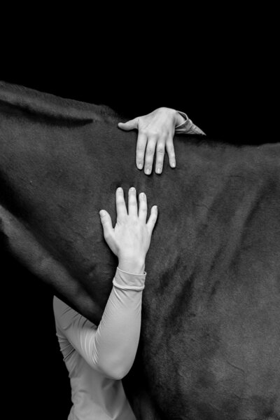Black and white photography of a girl hugging a horse's neck