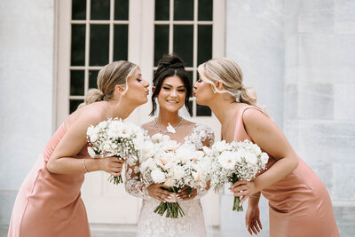 Whimsical wedding bouquet featuring pastel roses, dahlias, and lush greenery, created by Leigh Florist for a romantic garden ceremony.