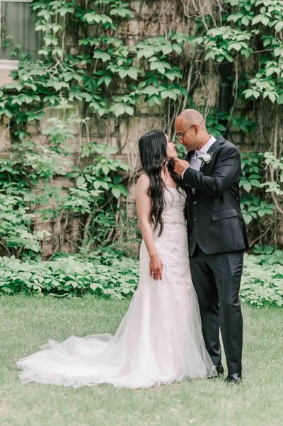 Bride holding husband's arm on a walking path at the U of S.
