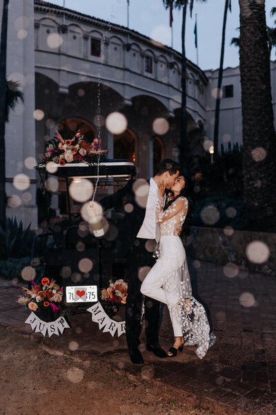 Destination elopement photographer captures Catalina Island elopement couple kissing in wedding attire during rain