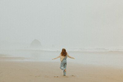 girl running on cannon beach