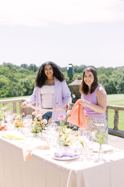 Sofi & Abbie setting a table