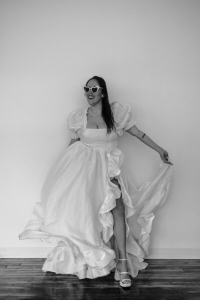 A bride twirling her dress around during her studio bridal session
