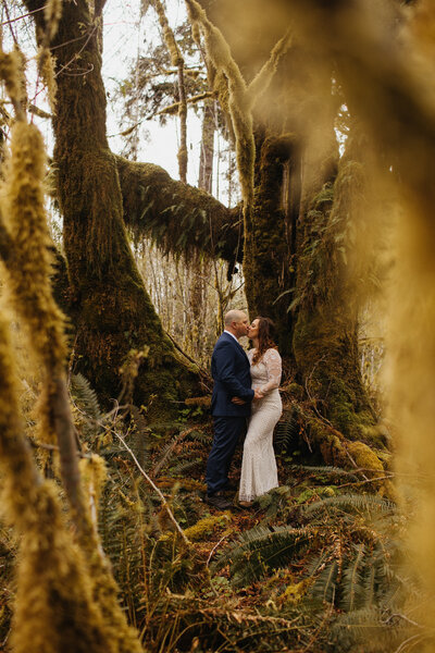 wedding elopement couple kissing in forest