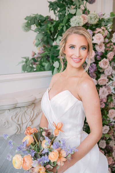 Bride standing in front of floral backdrop at Hillside Estate wedding in Dallas, by White Orchid Photography, Dallas wedding photographer