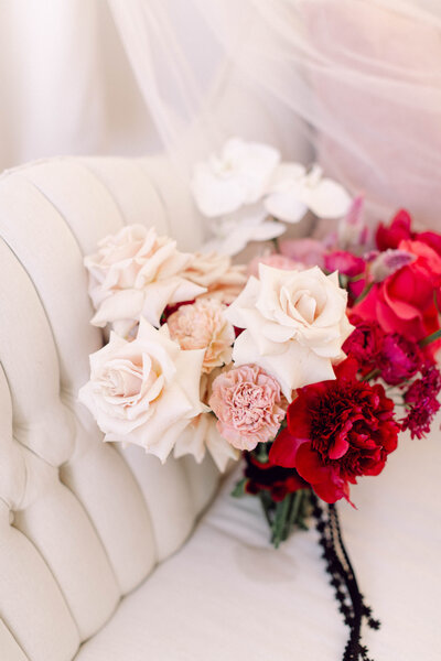 The bride’s lush bouquet resting on a white couch, styled in soft natural light before the ceremony at an intimate backyard wedding in Richmond, Virginia.