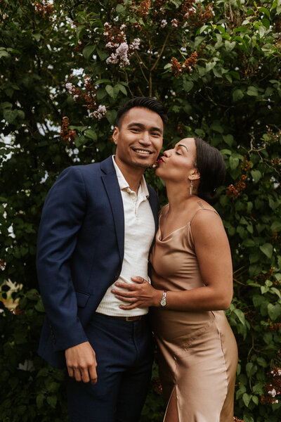 New England engagement photographer. Interracial couple (him - Taiwanese, her - Jamaican and white). Couple outdoors with greenery in the background.