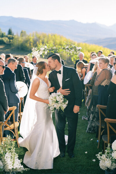 Bride and groom kiss at Aspen Wedding