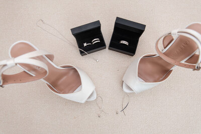 Chic wedding accessories featuring elegant bridal heels and wedding rings for a luxury celebration.