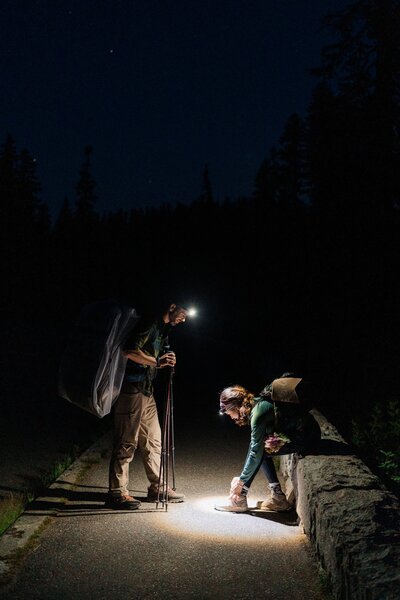 elopement couple lacing up their boots to begin a sunrise hike at Mt Rainier.