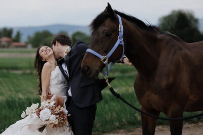 Bride and groom  ride horses during Colorado elopement day.