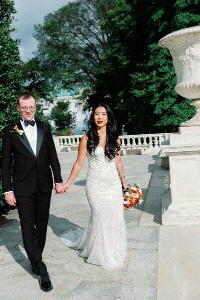 Bride and groom walk up memorial steps at their DC wedding