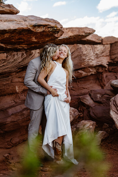 Two marriers look into one another's eyes in a forest.