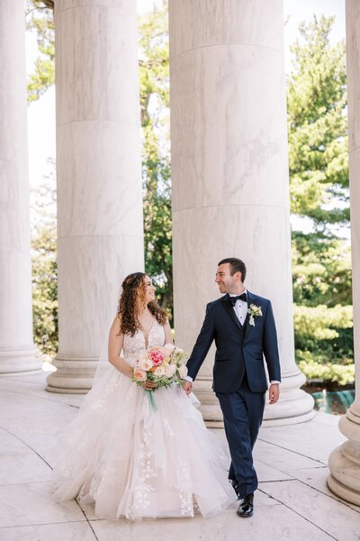 Bride and groom walk up memorial steps at their DC wedding