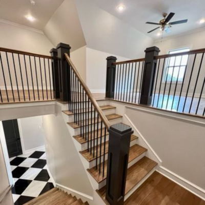 Staircase and landing with new hardwood floors.