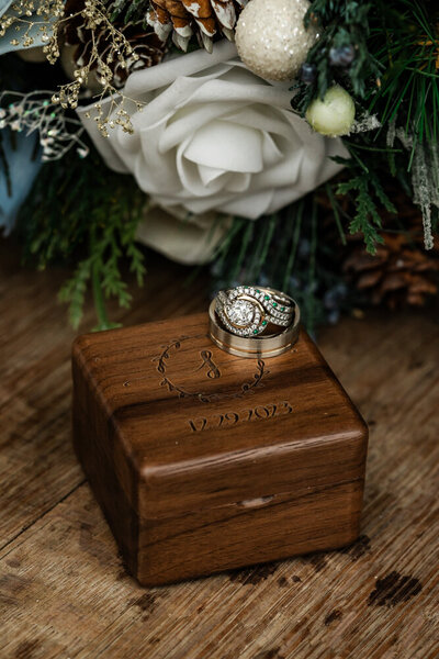 Rings sitting on top of a beautiful wooden ring box