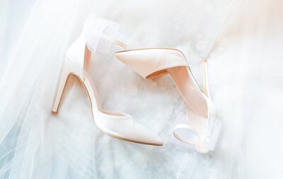 bridal shoes laying flat on veil detail photo