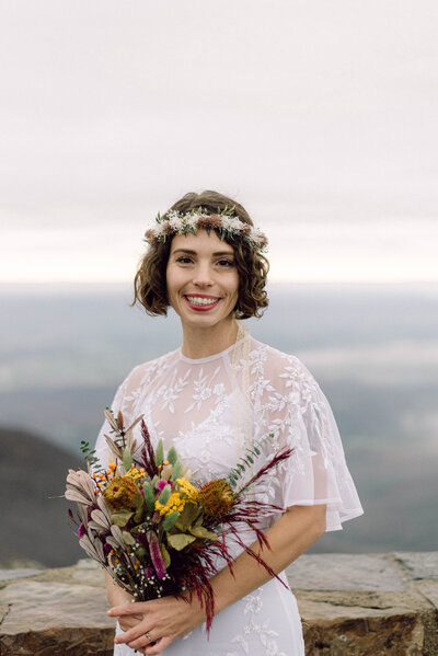 Close-up of the couple’s hiking boots resting on a mountaintop trail during their adventurous Virginia elopement, captured in a candid, editorial style.

