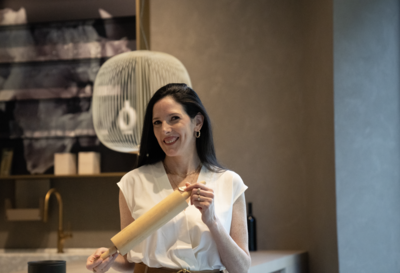 branding photo of cake maker in kitchen holding rolling pin