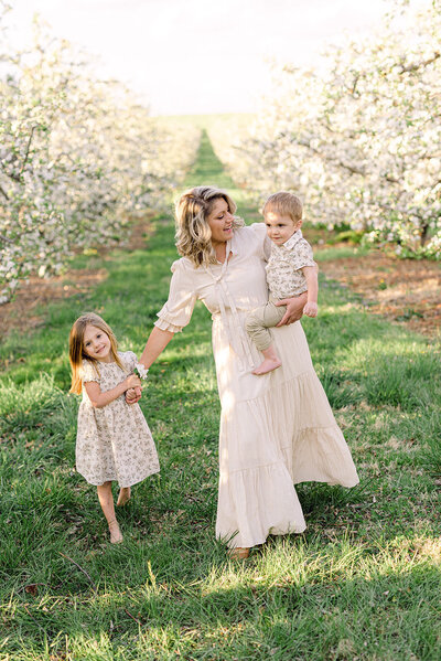 Mom walking in field with kids