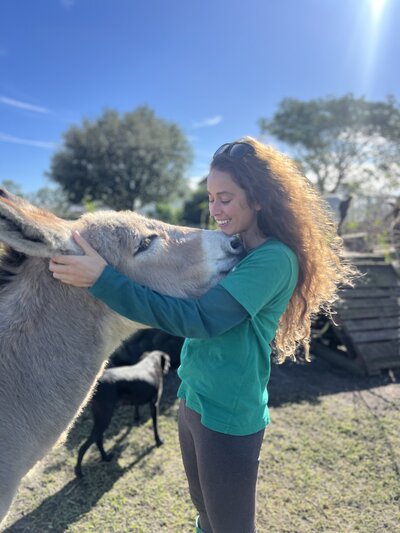 Nikki Vasconez hugging a donkey